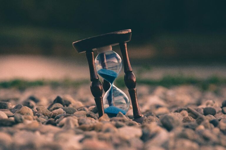 Our Time Has Come: Image of hourglass on a rocky terrain